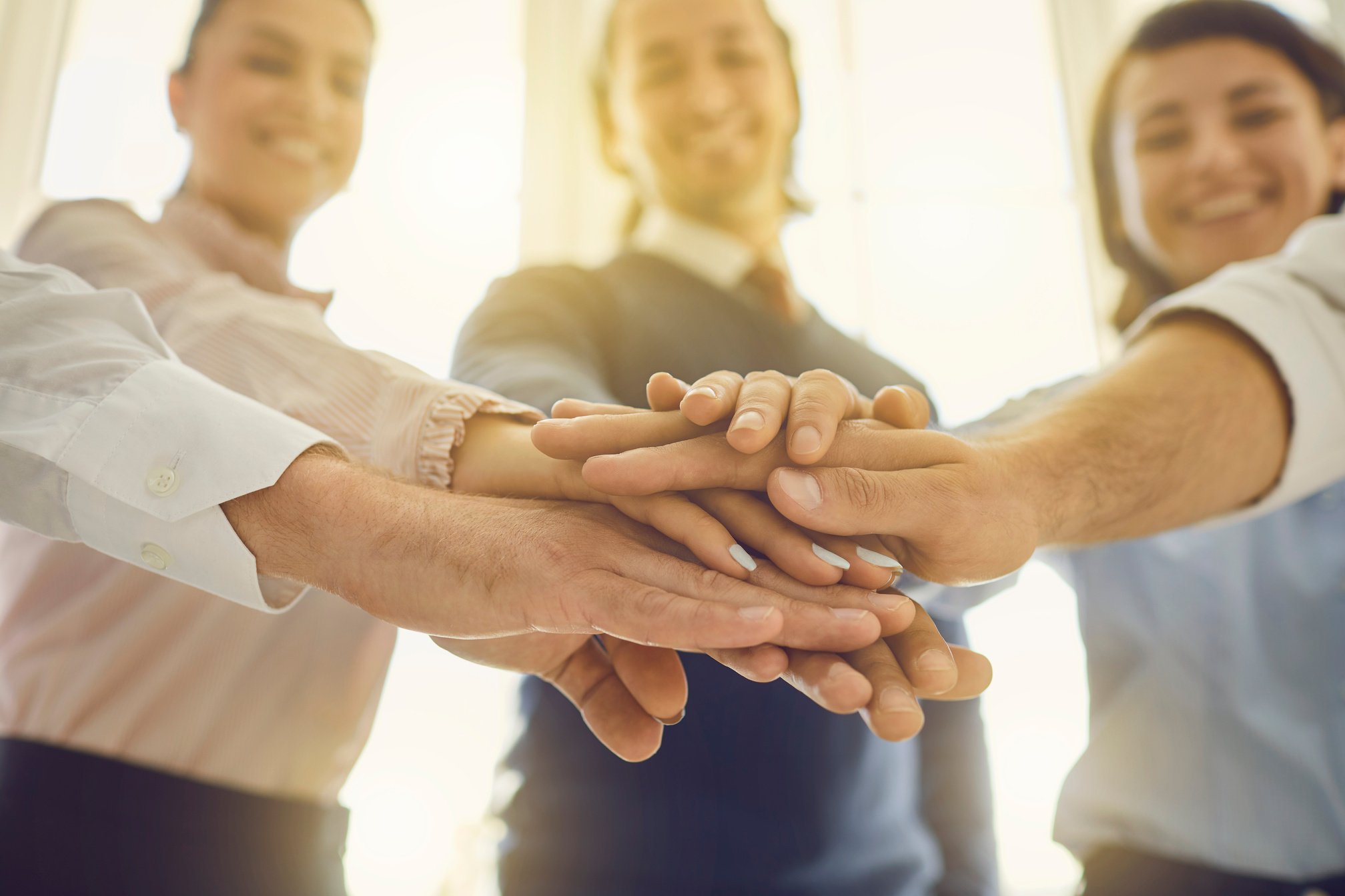 Close-up of Smiling Business People Hands Pyramid Expressing Successful Project Realization or Development